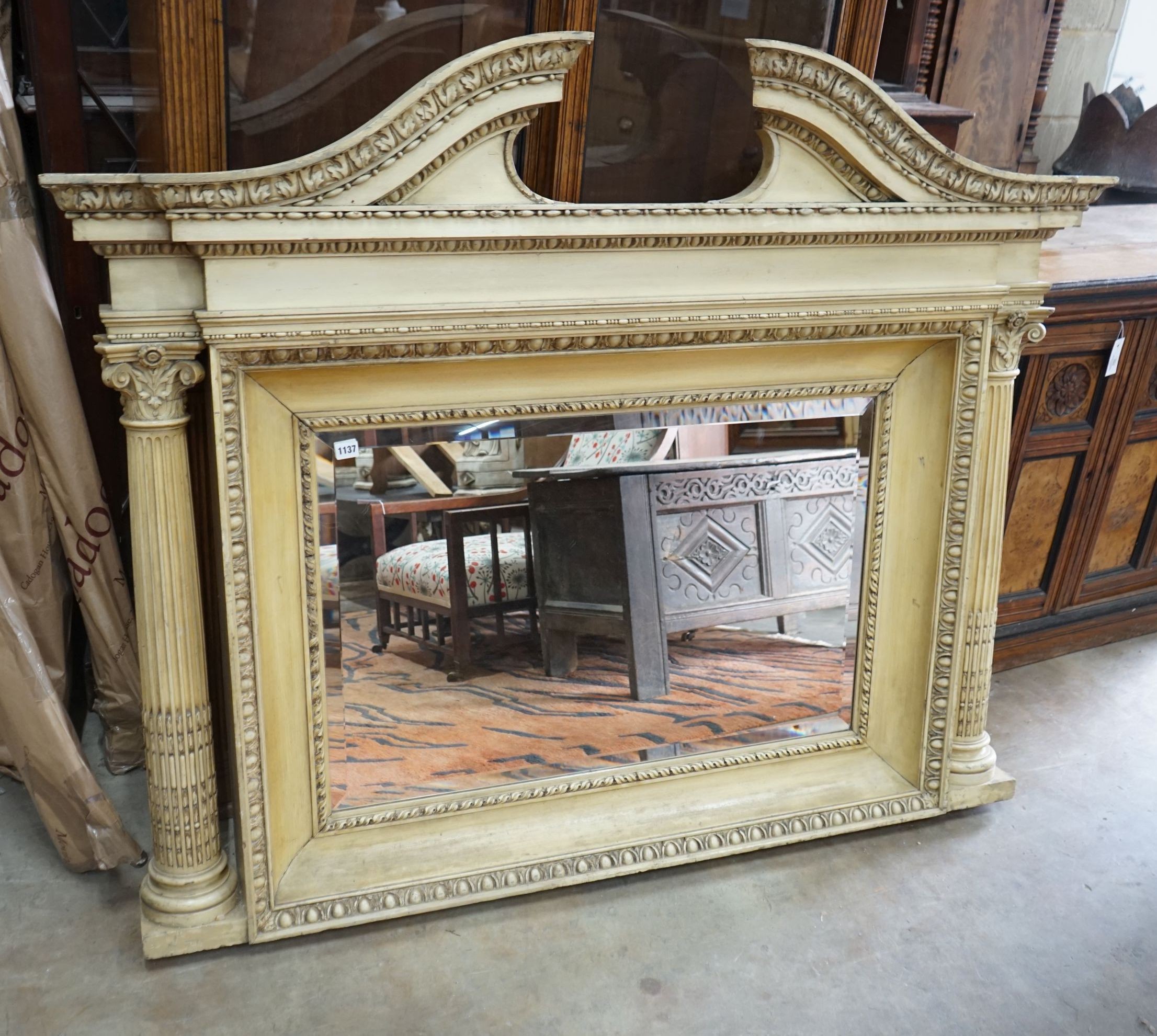 A George III style painted wood and gesso overmantel mirror with rectangular bevelled plate flanked by Corinthian columns, width 152cm, height 122cm